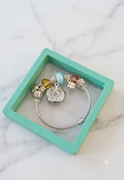 Women's bracelet watch with multicolor beads and decorative charms around the strap, featuring a round analog dial